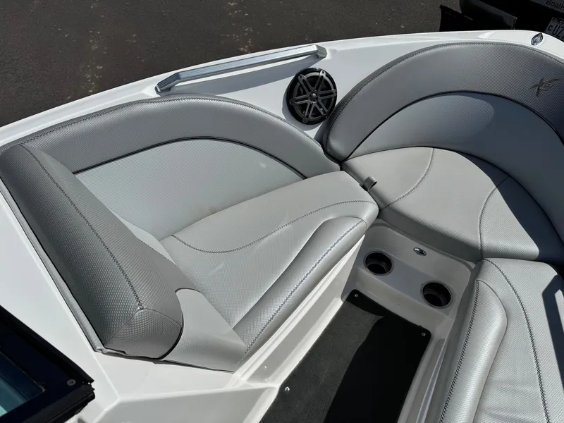 Slide: The Image of The image shows the bow area of a 2016 MasterCraft X10 with gray upholstery and speakers. - 16