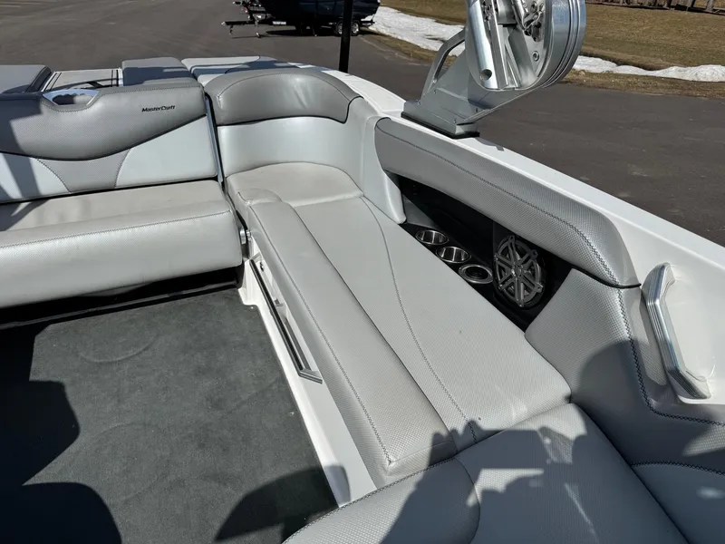 Slide: The Image of The image shows the interior of a 2016 MasterCraft X10 boat with gray upholstery. - 20