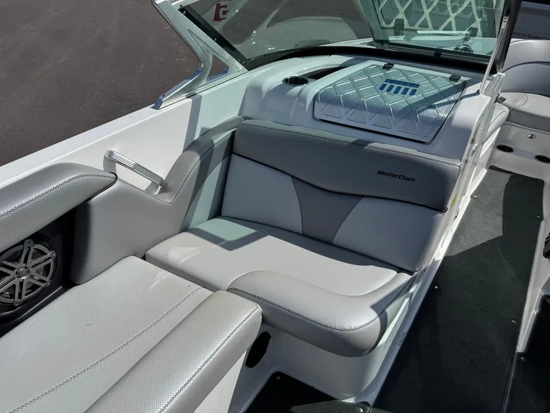 Slide: The Image of The image shows the interior of a 2016 MasterCraft X10 boat with gray upholstery. - 19