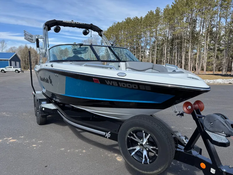 Slide: The Image of A 2016 MasterCraft X10 boat on a trailer in a parking lot. - 7
