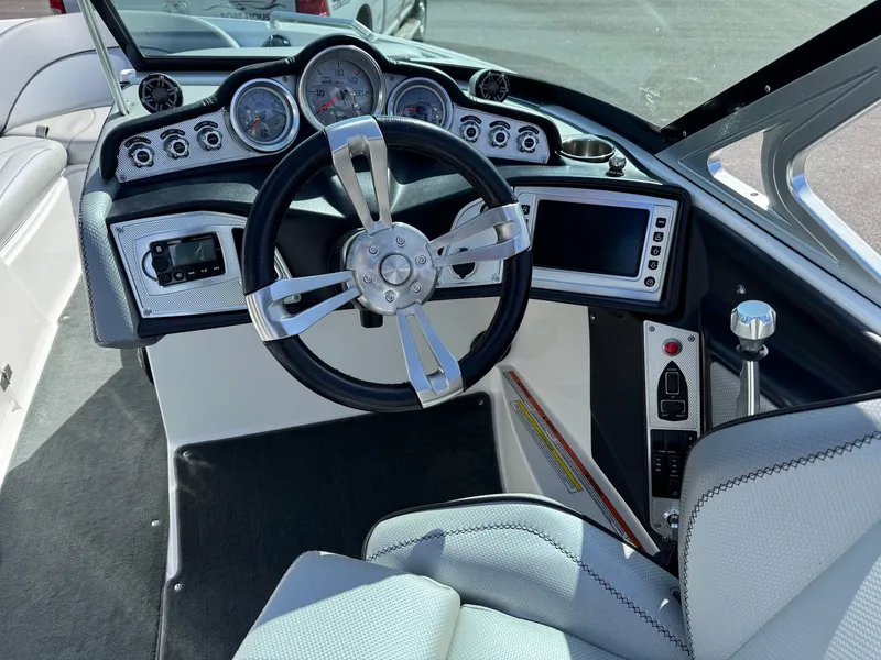 Slide: The Image of The image shows the cockpit of a 2016 MasterCraft X10 with a modern steering wheel and instruments. - 24