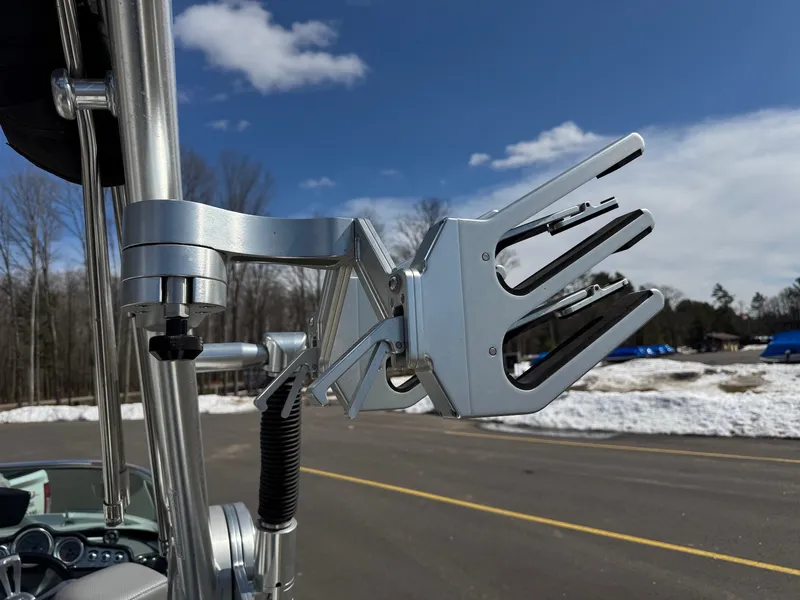 Slide: The Image of A silver wakeboard rack on a boat, surrounded by snowy ground and blue sky. - 29
