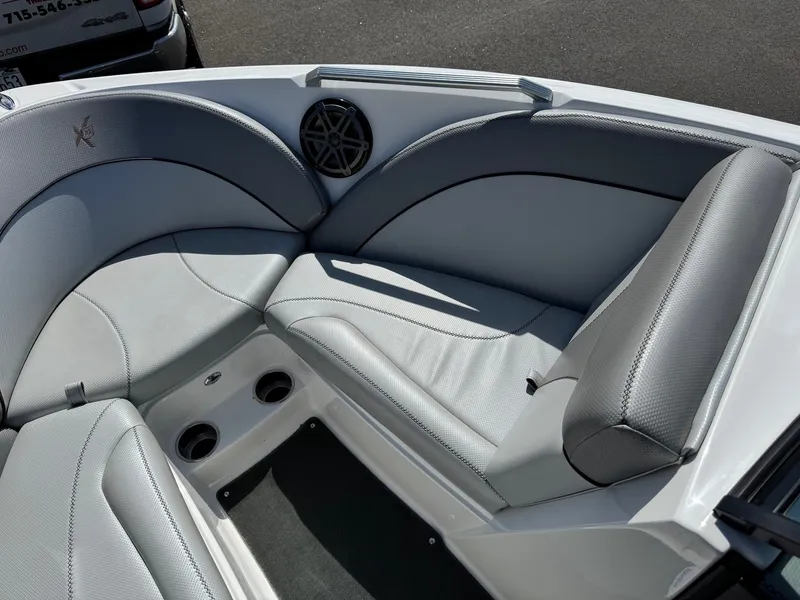 Slide: The Image of The image shows the bow area of a 2016 MasterCraft X10 boat with gray upholstery and speakers. - 17