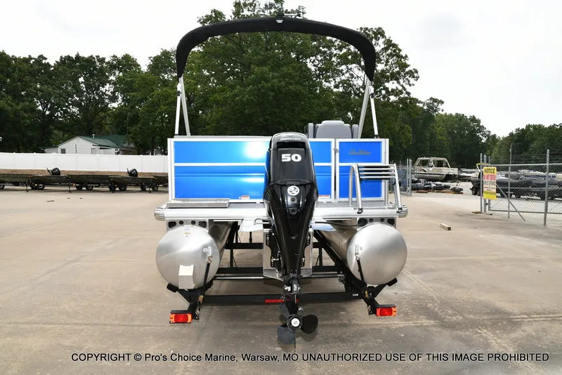 Slide: The Image of A 2027 Sun Tracker Party Barge 16 on a trailer. The outboard motor is visible. - 16