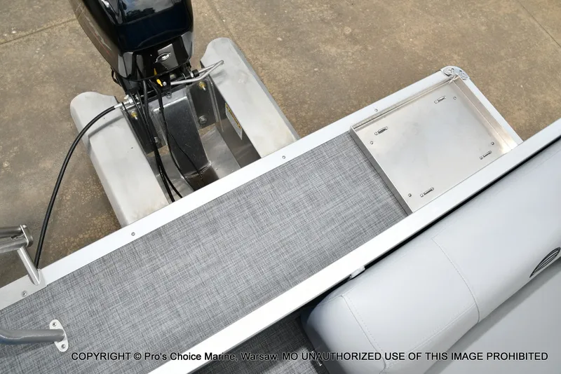 Slide: The Image of The image shows the stern of a 2027 Sun Tracker Party Barge 16 with an outboard motor. - 12