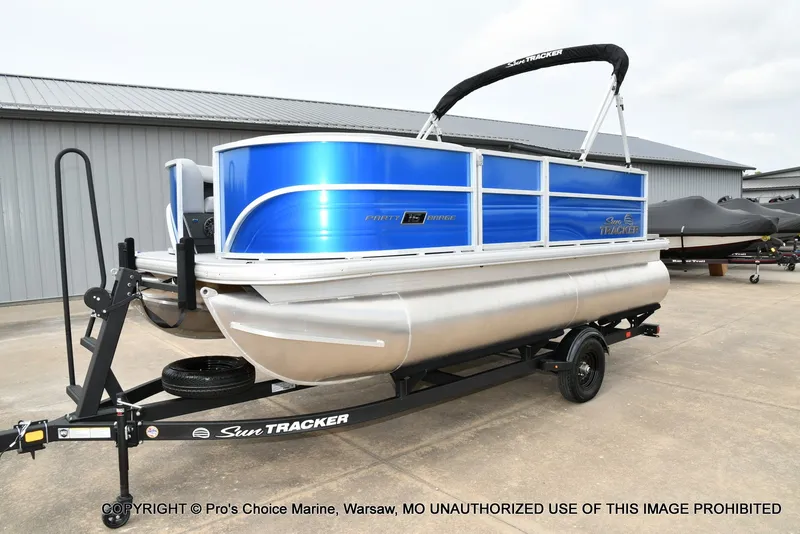 Slide: The Image of A 2027 Sun Tracker Party Barge 16 on a trailer in a storage area. - 13