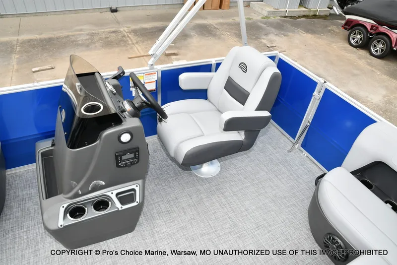 Slide: The Image of The image shows the cockpit of a 2027 Sun Tracker Party Barge 16 with gray seating. - 4