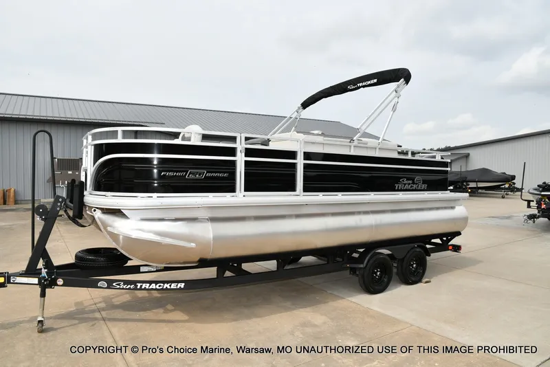 Slide: The Image of A 2027 Sun Tracker Fishin' Barge 20 DLX on a trailer in an outdoor setting. - 15