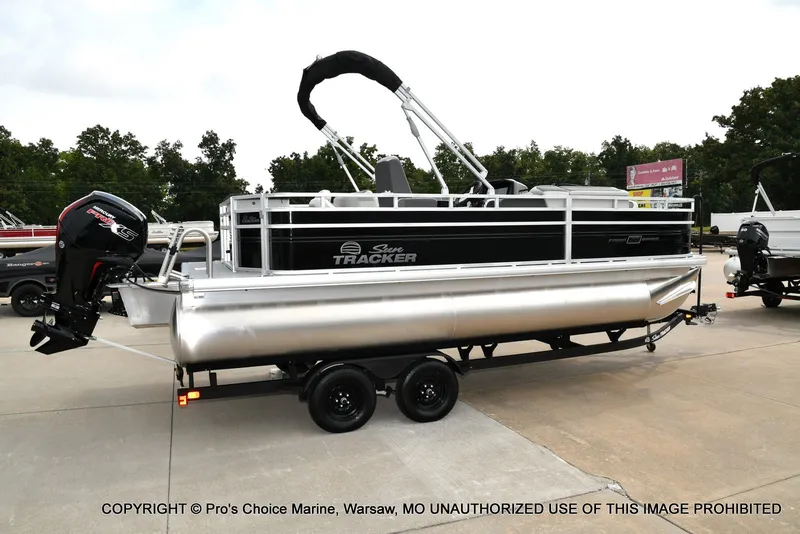 Slide: The Image of A Sun Tracker Fishin' Barge 20 DLX pontoon boat on a trailer, ready for transport. - 18