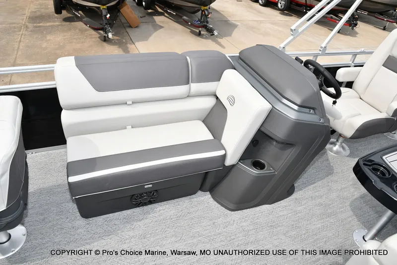 Slide: The Image of The 2027 Sun Tracker Fishin' Barge 20 DLX features a gray and white bench seat with storage underneath. - 3