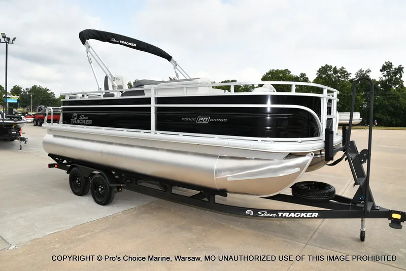 Slide: The Image of A Sun Tracker Fishin' Barge 20 DLX pontoon boat on a trailer, ready for transport. - 16