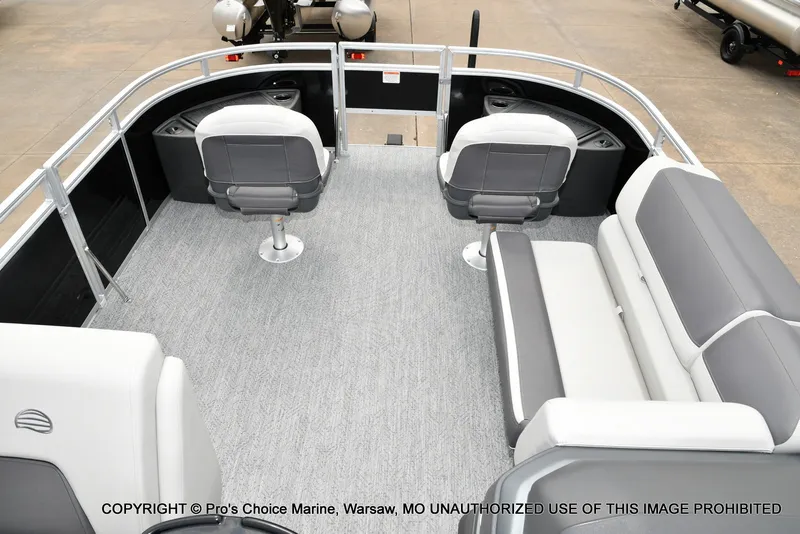 Slide: The Image of Interior view of a 2027 Sun Tracker Fishin' Barge 20 DLX with gray seating and carpeted floor. - 14