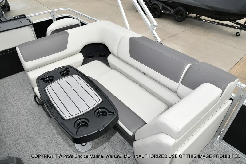 Slide: The Image of The image shows a gray and white seating area on a boat with a table in the center. - 6