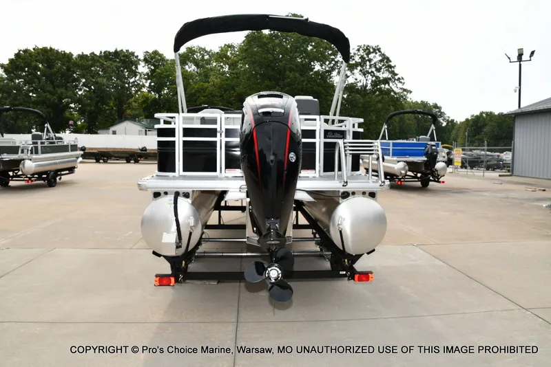 Slide: The Image of The image shows a 2027 Sun Tracker Fishin' Barge 20 DLX on a trailer. - 19