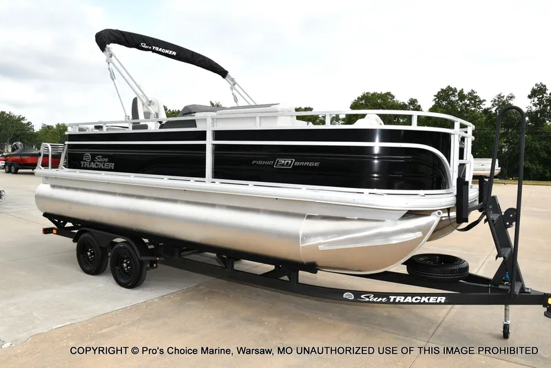 The Image of A 2027 Sun Tracker Fishin' Barge 20 DLX pontoon boat on a trailer. - 1