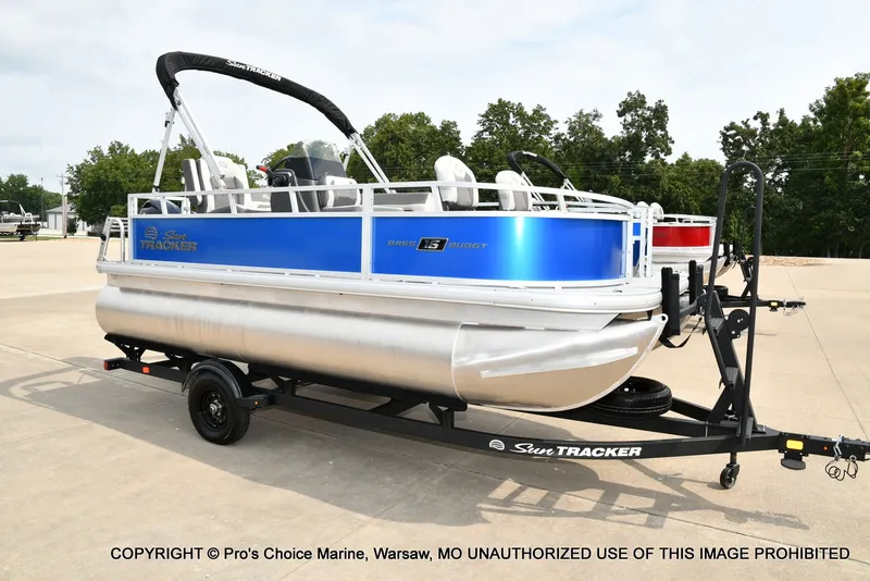 The Image of A Sun Tracker Bass Buggy 16 XL Select pontoon boat on a trailer, ready for transport. - 1