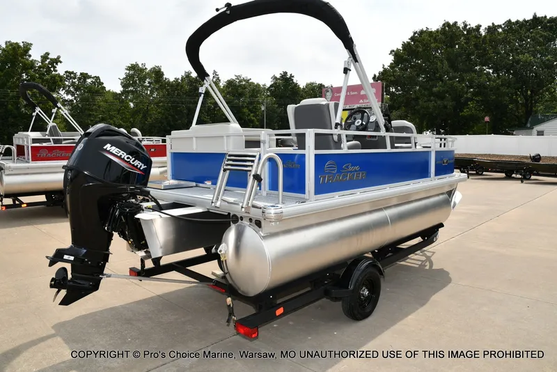 Slide: The Image of A Sun Tracker Bass Buggy 16 XL Select pontoon boat with a blue hull and black outboard motor. - 17