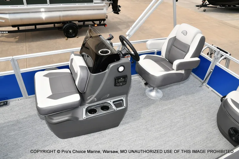 Slide: The Image of The image shows the cockpit of a 2027 Sun Tracker Bass Buggy 16 XL Select with two cushioned seats and a helm. - 5