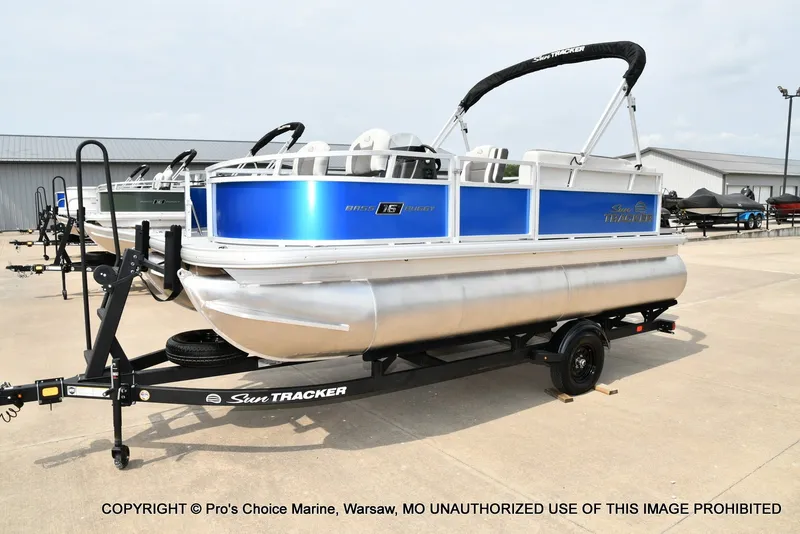 Slide: The Image of A Sun Tracker Bass Buggy 16 XL Select pontoon boat on a trailer, ready for transport. - 21
