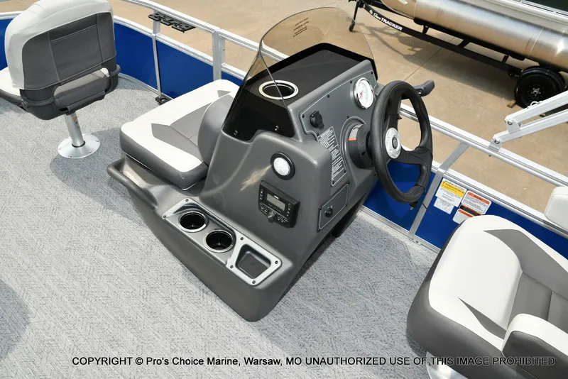Slide: The Image of The image shows the cockpit of a 2027 Sun Tracker Bass Buggy 16 XL Select with gray seats. - 12