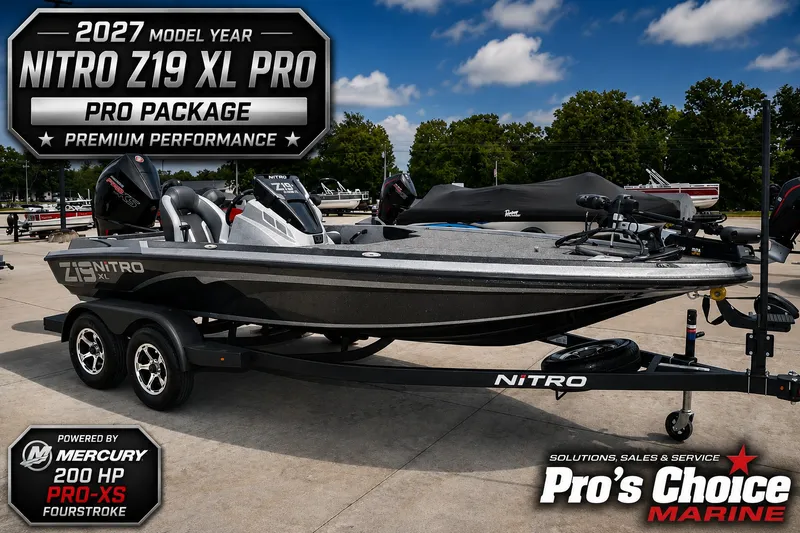 The Image of A gray Nitro Z19 XL Pro boat on a trailer, surrounded by other boats and trees. - 1