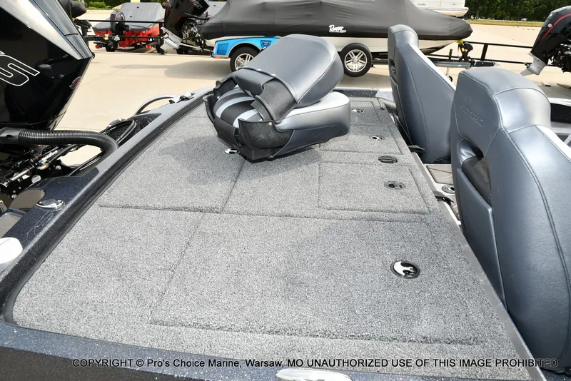 Slide: The Image of The image shows the deck of a Nitro Z19 XL Pro boat with gray carpeting and a folded seat. - 39