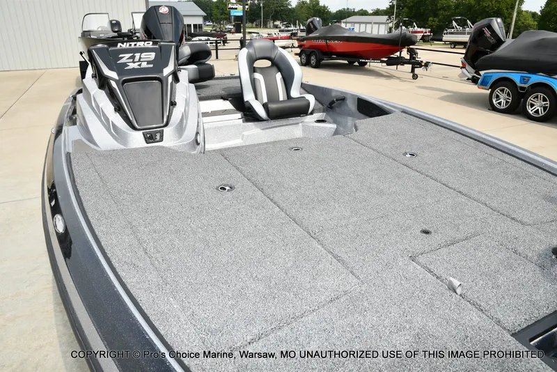 Slide: The Image of The image shows a 2027 Nitro Z19 XL Pro boat with gray carpeting and two seats. - 38