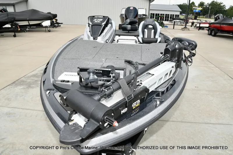 Slide: The Image of A modern fishing boat with a gray hull and two seats, equipped with a Minn Kota trolling motor. - 33