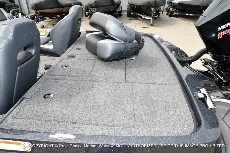 Slide: The Image of The image shows the deck of a Nitro Z19 XL Pro boat with gray carpeting. - 42