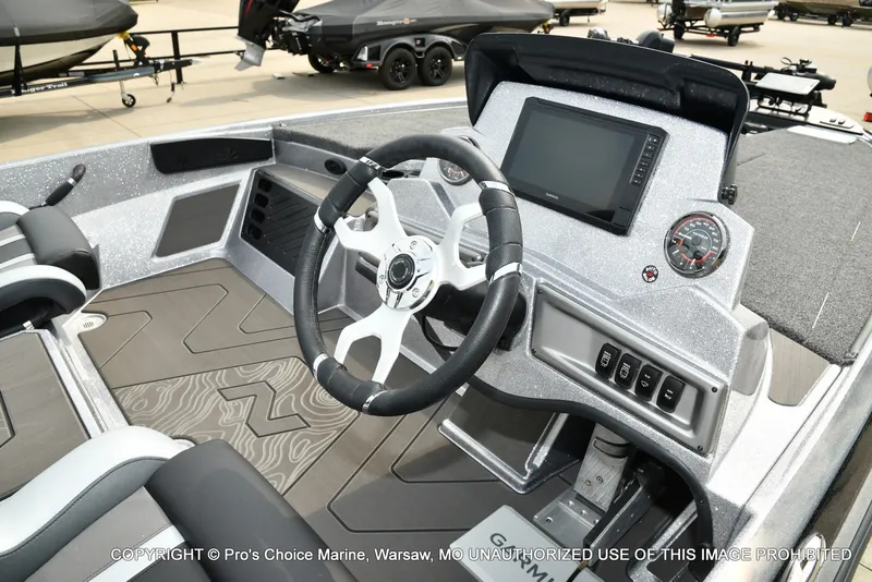 Slide: The Image of The image shows the cockpit of a Nitro Z19 XL Pro boat with a modern steering wheel and large display. - 12