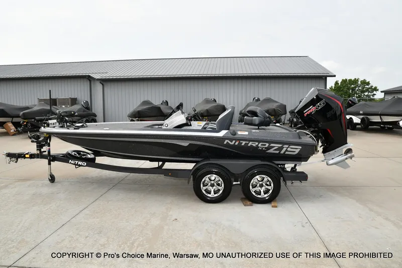 Slide: The Image of The image shows a 2027 Nitro Z19 XL Pro boat on a trailer, parked on a concrete lot. - 30