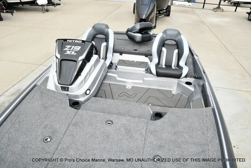 Slide: The Image of The image shows the deck of a Nitro Z19 XL Pro boat with gray carpeting and two seats. - 21