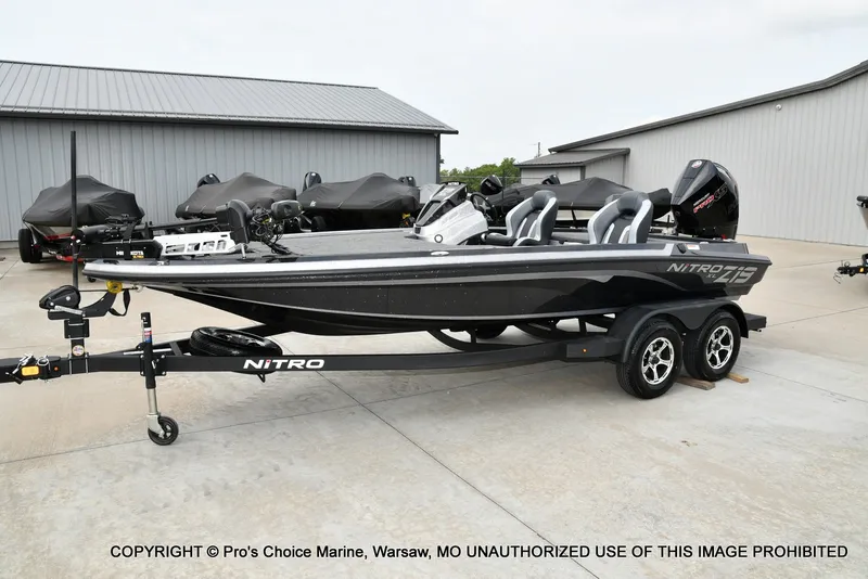 Slide: The Image of A black Nitro Z19 XL Pro boat on a trailer in a storage area. - 6