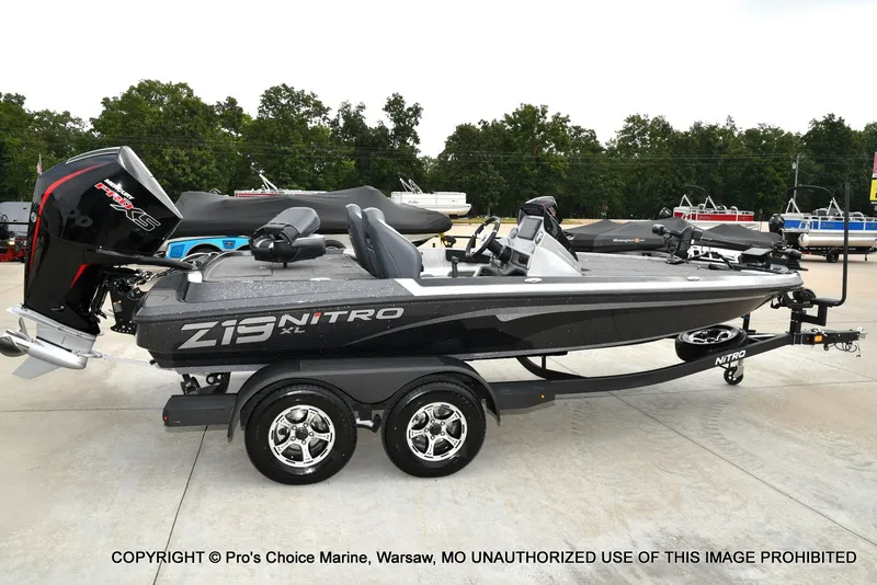 Slide: The Image of A gray Nitro Z19 XL Pro boat from 2027 is on a trailer in a parking lot. - 25