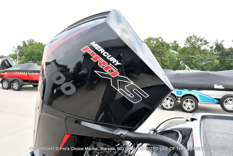 Slide: The Image of A Mercury Pro XS outboard motor is attached to a boat. Other boats are visible in the background. - 5