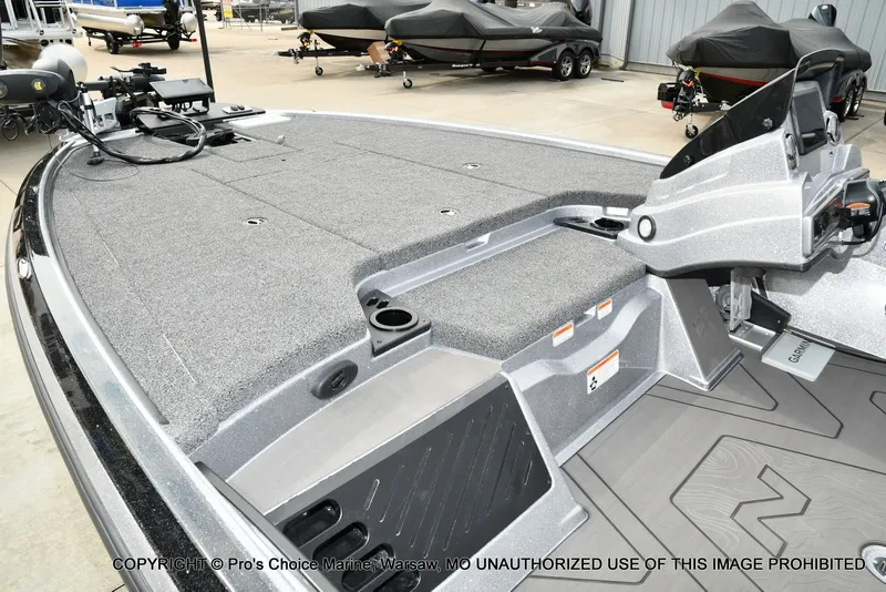 Slide: The Image of The image shows the deck of a Nitro Z19 XL Pro boat with gray carpeting and storage space. - 14