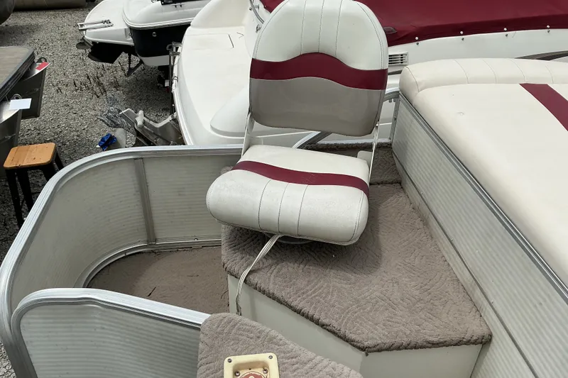 Slide: The Image of 2003 Lowe Trinidad 220 boat interior with white and red seating. - 11
