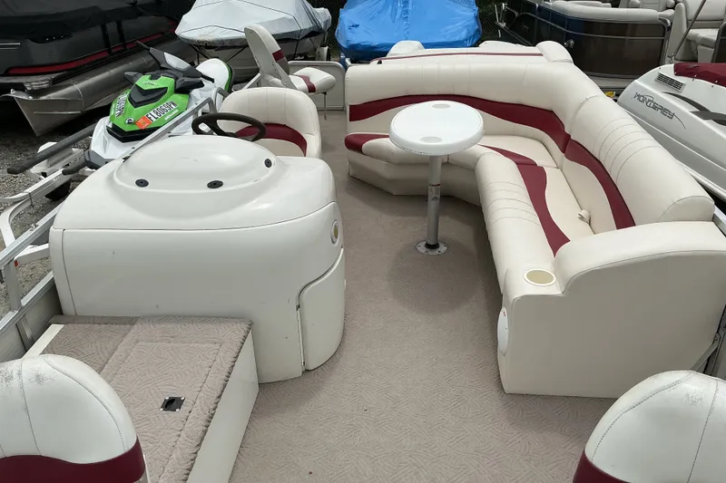 Slide: The Image of 2003 Lowe Trinidad 220 pontoon boat interior with seating and table. - 6