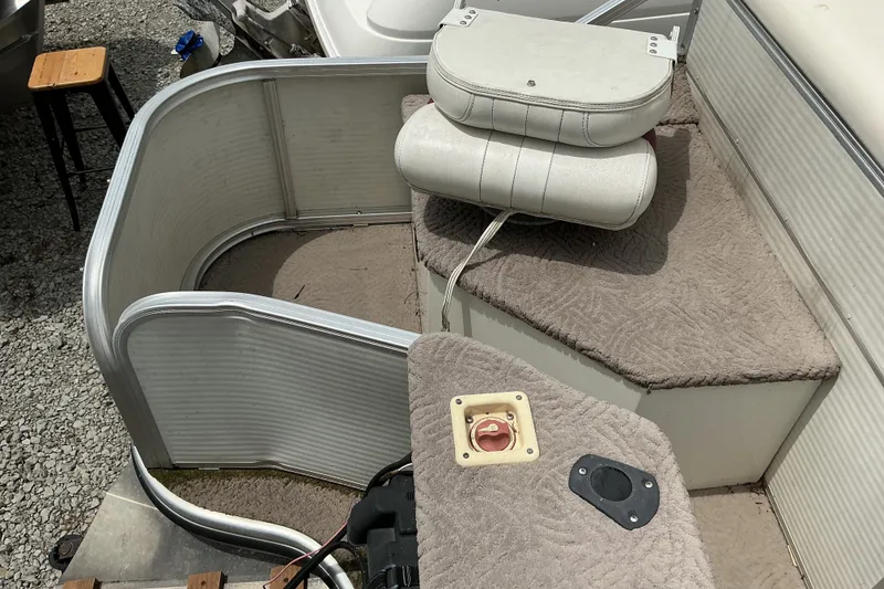 Slide: The Image of 2003 Lowe Trinidad 220 boat interior with carpeted deck and white cushions. - 9