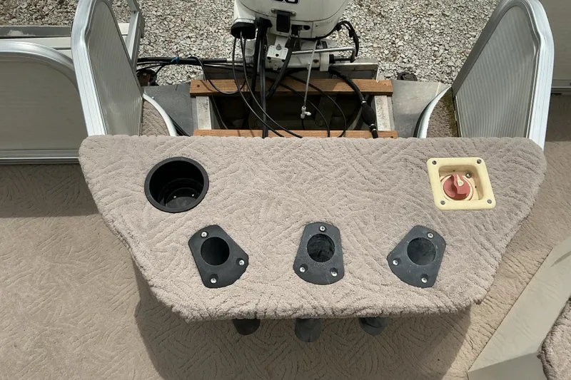 Slide: The Image of 2003 Lowe Trinidad 220 boat deck with cup holder and control panel. - 12