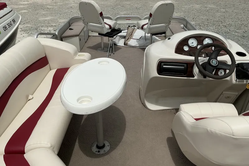 Slide: The Image of Interior of a 2003 Lowe Trinidad 220 pontoon boat with seating and steering console. - 8