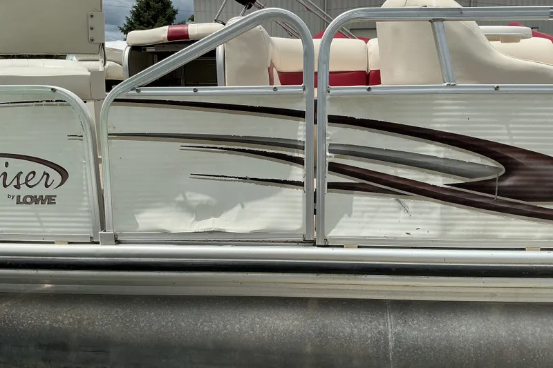 Slide: The Image of Damaged side panel of a 2003 Lowe Trinidad 220 pontoon boat. - 15