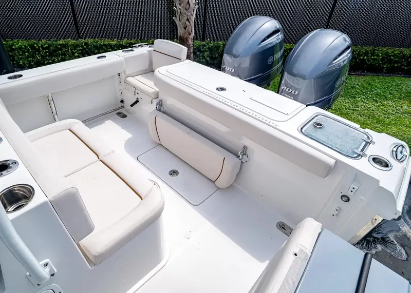 Slide: The Image of The image shows the cockpit of a 2020 Sea Hunt Gamefish 27CB with two outboard engines. - 7
