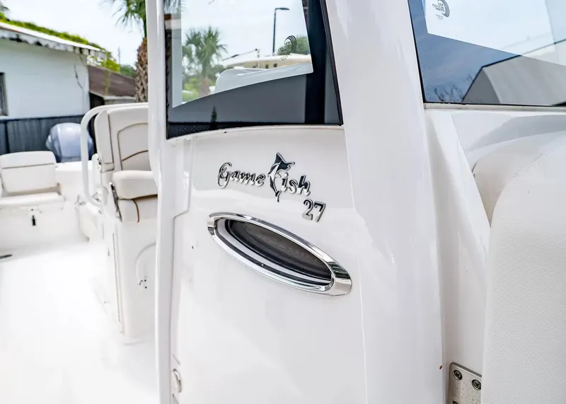 Slide: The Image of Close-up of the 2020 Sea Hunt Gamefish 27CB, featuring the logo and white interior. - 22