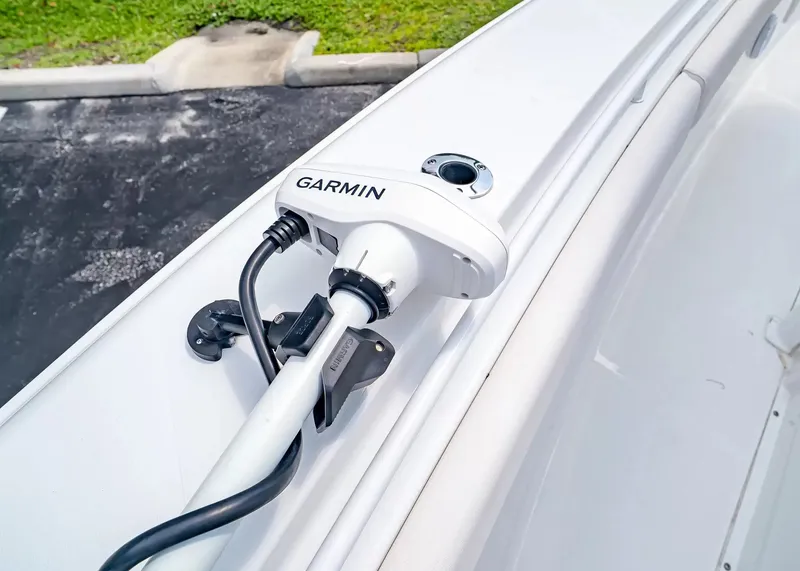 Slide: The Image of A Garmin device is mounted on a white boat parked in a lot. - 27