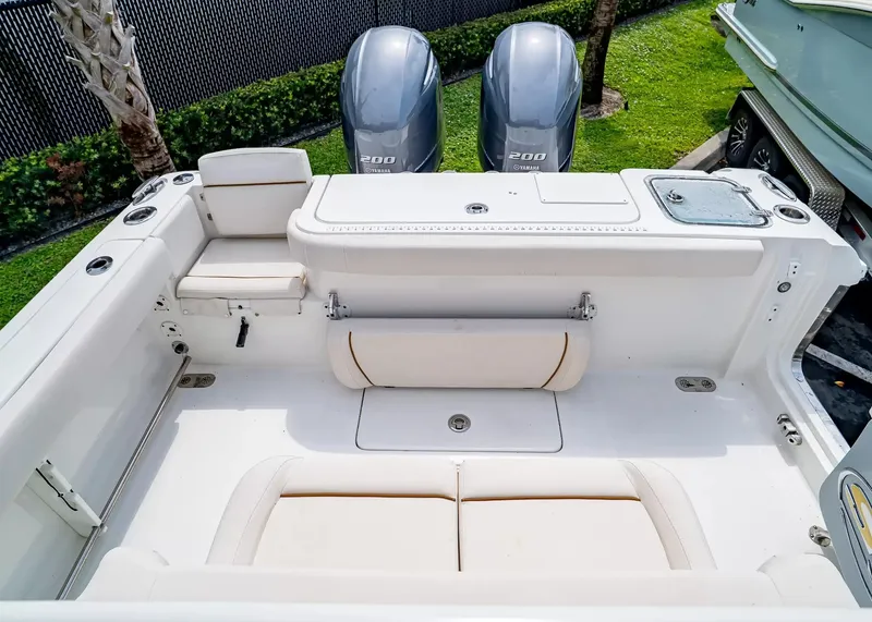Slide: The Image of The image shows the cockpit of a 2020 Sea Hunt Gamefish 27CB with two outboard engines. - 6