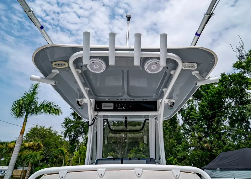 Slide: The Image of The image shows the roof of a Sea Hunt Gamefish 27CB boat with rod holders and speakers. - 16