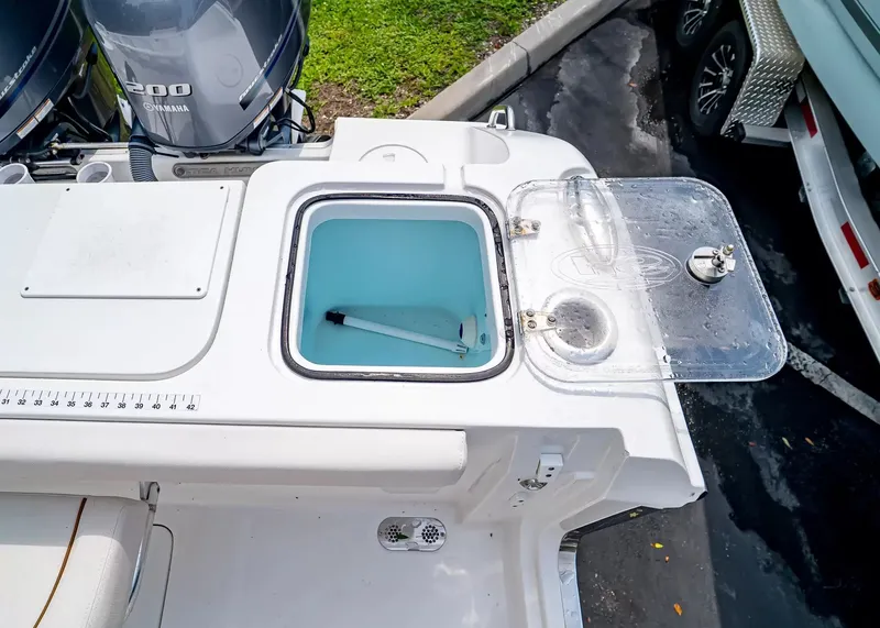 Slide: The Image of The image shows the stern of a Sea Hunt Gamefish 27CB with an open livewell. - 10