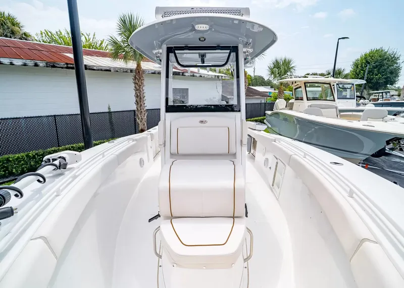 Slide: The Image of The image shows a 2020 Sea Hunt Gamefish 27CB boat with a clean, white deck and seating. - 30