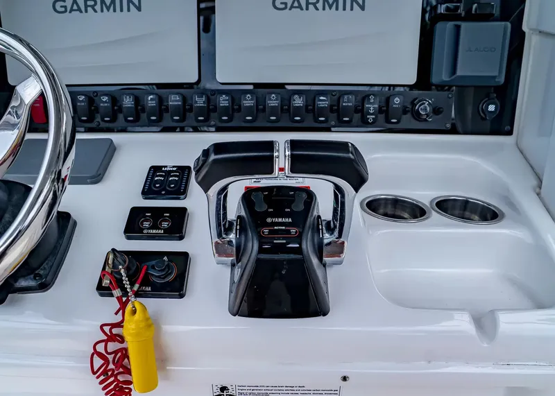 Slide: The Image of The image shows the helm of a Sea Hunt Gamefish 27CB with Yamaha controls and Garmin screens. - 21